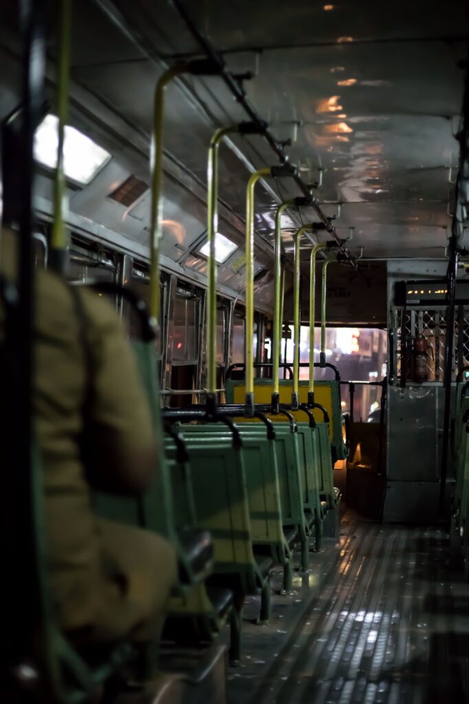 local best bus inside photo with empty seats and conductor's arm visible in khaki uniform