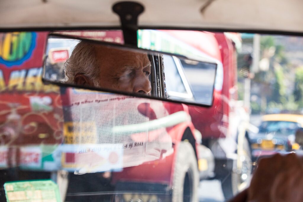 taxi rear view mirror eyes of taxi driver lost in thoughts in mumbai traffic jam