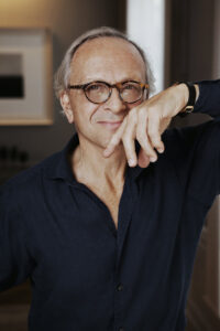 christian liaigre standing with glasses and smiling